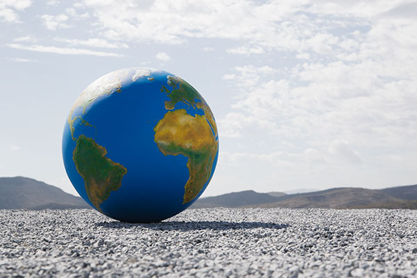 A globe in a desert landscape.