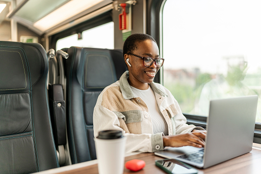 woman working on laptop on a train
