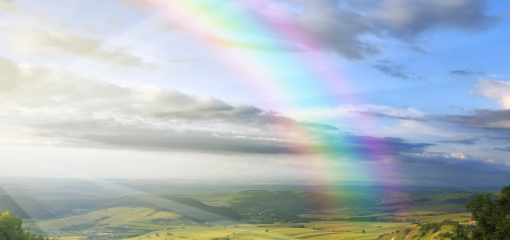 Rainbow over green landscape