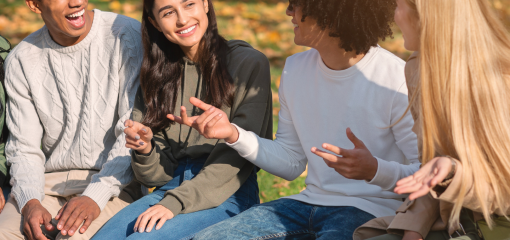 Four people sitting and talking