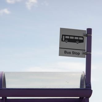 bus stop sign against the blue sky