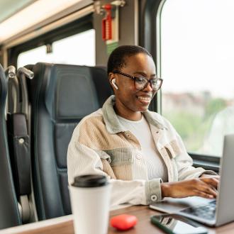 woman working on laptop on a train