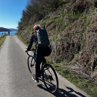 person on bicycle with backpack on