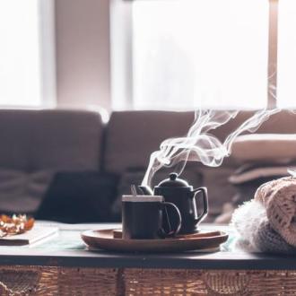 A steaming cup of tea in a living room