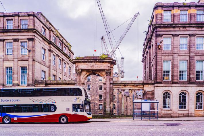 A bus driving a long the road in Edinburgh.