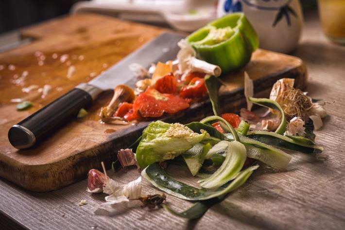Food waste next to a chopping board