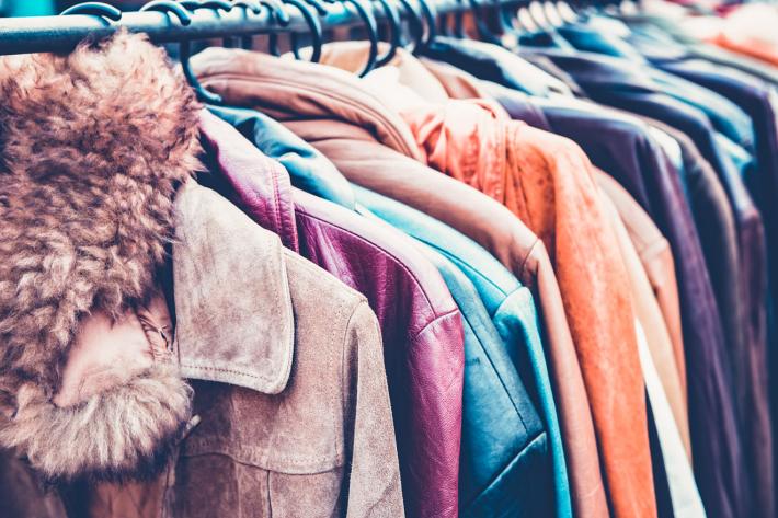 A row of second hand clothing on a clothes rail