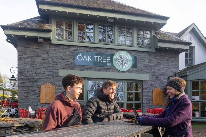 A family sitting outside the Oak Tree