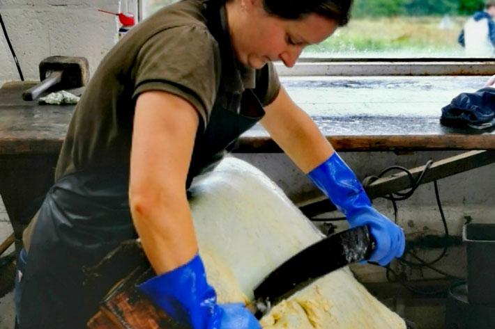 A person scraping a sheepskin rug