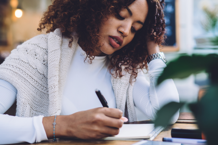 Woman writing in a notepad