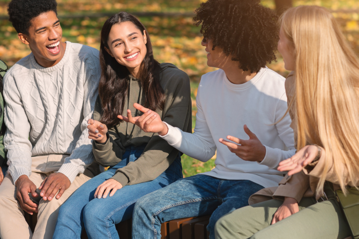 Four people sitting and talking