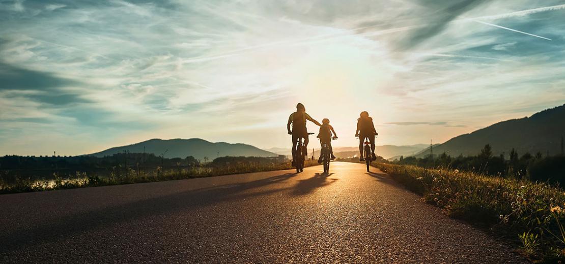 People cycling into the sunset