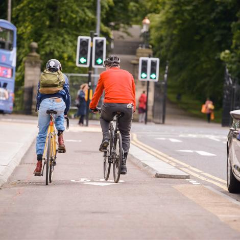 Two people cycling along a cycle path