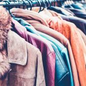 A row of second hand clothing on a clothes rail