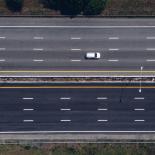 Large motorway with a single car from bird's eye view